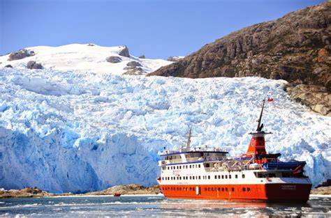 Vibrant red cruise ship navigating icy waters near a sprawling blue glacier, ideal for adventure cruises in Alaska