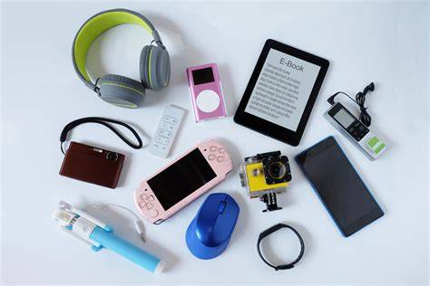 Collection of travel gadgets including headphones, e-book reader, camera, and more