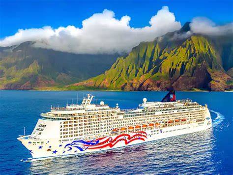 A luxury cruise ship sailing near the stunning cliffs and lush landscapes of the Na Pali Coast in Hawaii.