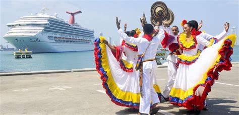 Traditional dancers in colorful attire performing in front of a cruise ship docked in Cartagena, Colombia