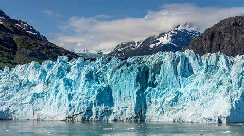 Majestic Glacier in Majestic glacier in Glacier Bay National Park, Alaska with snow-capped mountains in the background