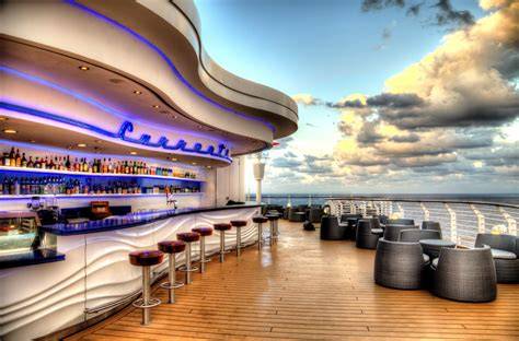 Rooftop bar on a cruise ship with ocean views at sunset