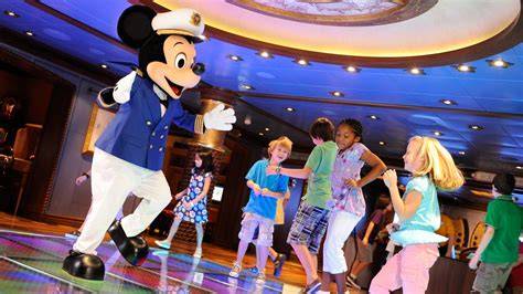 Children dancing and interacting with a Mickey Mouse character onboard a cruise ship