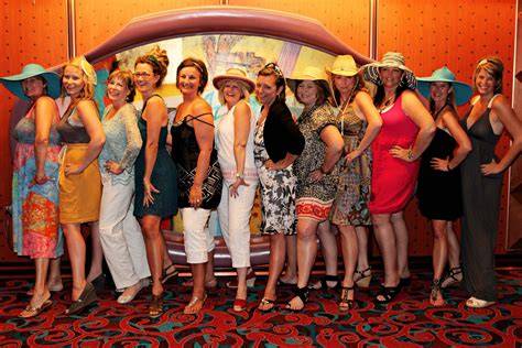 Group of women posing together on a cruise ship, dressed for a themed party.