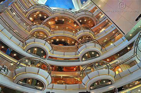 Interior view of a cruise ship showcasing multiple decks and balconies with elegant lighting