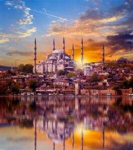 Sunset view of the Blue Mosque with its reflection in the water in Istanbul, Turkey