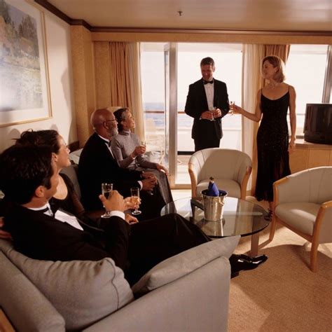 Elegant group enjoying a formal gathering in a cruise ship cabin.