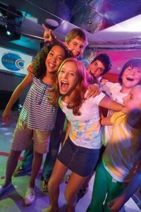 Group of happy children enjoying onboard activities on a cruise ship