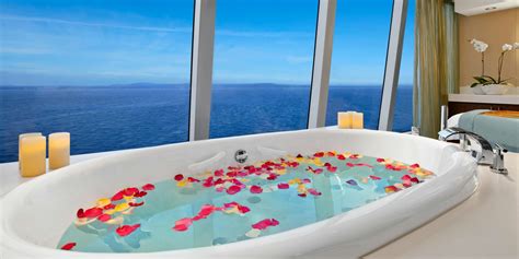 Luxurious bathtub with rose petals and ocean view on a luxury cruise ship.