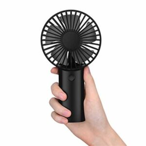 Hand holding a black portable handheld fan