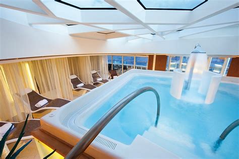 Luxurious indoor pool and lounge area with ocean views onboard a cruise ship