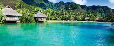 Overwater bungalows with lush tropical scenery and turquoise waters.