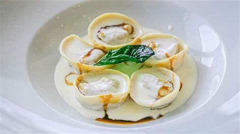 Gourmet pasta dish with a creamy sauce served on a luxury cruise ship.