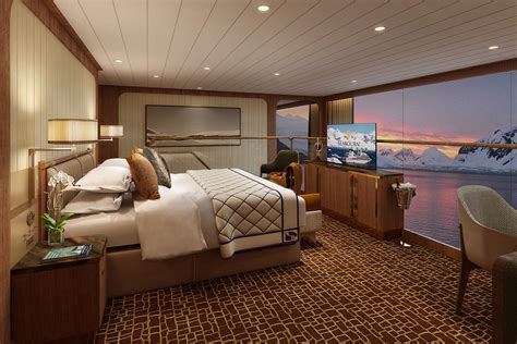 Luxurious cruise ship cabin with a panoramic window view of a snowy landscape