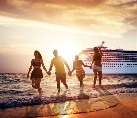 Friends Enjoying Sunset Beach with Cruise Ship in Background - America's Best Group Cruises Group of friends holding hands on the beach with a cruise ship in the background at sunset