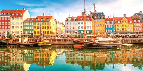 Colorful buildings and boats along the waterfront in Nyhavn, Copenhagen.