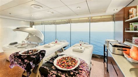 Luxurious spa treatment room with massage tables and ocean view onboard a cruise ship