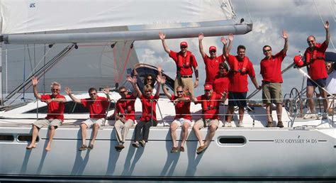 Team in red shirts on a sailing yacht during a corporate cruise event