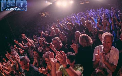 Excited crowd enjoying a live concert on a music cruise