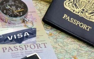 Passports, a visa, and a compass on a map, symbolizing travel preparation