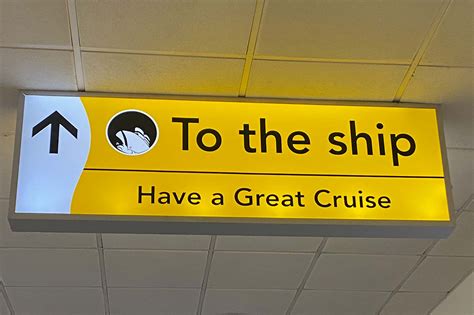 Yellow sign indicating the direction to the ship with the message "Have a Great Cruise