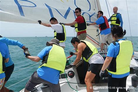 Team working together on a sailing boat during a corporate cruise event