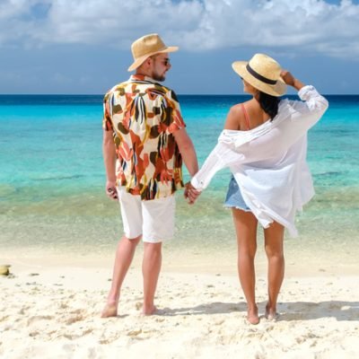 Playa Porto Marie Beach in Curacao, a tropical beach on the Caribbean Island of Curacao. A couple of men and women on the beach in Curacao
