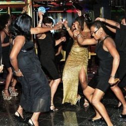 Group of women dancing and enjoying a party on a cruise ship